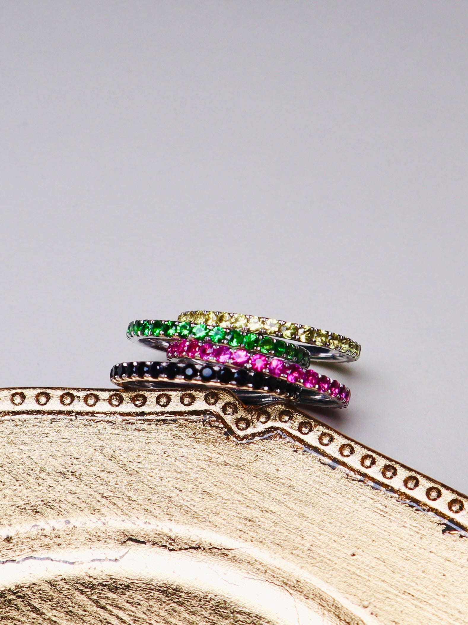 Gold ring band set with colored sapphires
